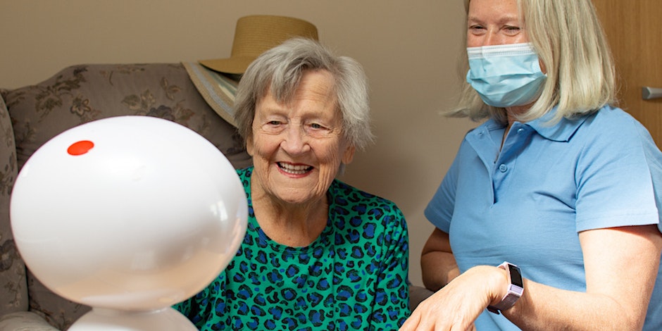 Care worker, Genie and care recipient happy